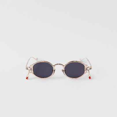 Picture of golden tear-shaped sunglasses blood